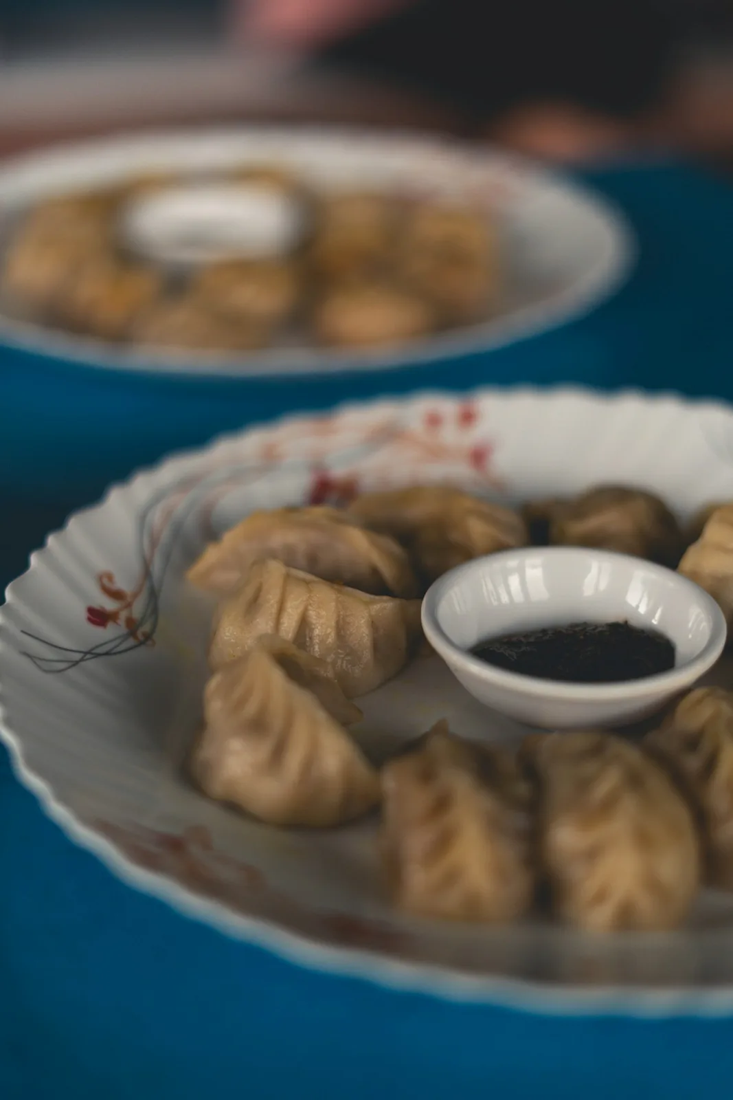 Steamed Nepali momo served with sesame and tomato chutney